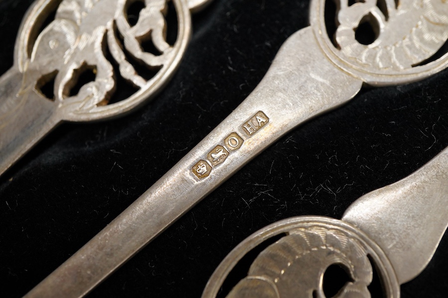Four assorted cased silver sets including two handled christening bowl and spoon, Birmingham, 1934, a similar christening mug, set of six teaspoons with sugar tongs and six George V lobster picks.